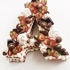 there is a chocolate cake with strawberries on top and whipped cream around the edges