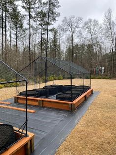 an empty trampoline in the middle of a field