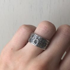 Sterling silver wide, floral cigar band ring. Be mindful, because of the wide band, this ring fits snug + it is recommended to go up one size. Size 7, 8 Width: 11mm Made in USA Adjustable Wide Band Ring For Everyday, Adjustable Wide Band Ring Stamped 925, Adjustable Wide Band Dome Ring As Gift, Be Mindful, Go Up, Ring Fit, Wide Bands, Cigars, Band Ring