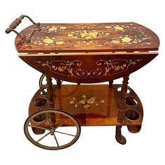 an antique wooden cart with wheels and flowers painted on it