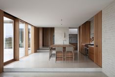 an open kitchen and dining room with sliding glass doors