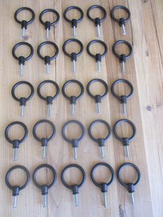 a bunch of black rings on a wooden floor