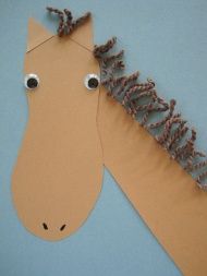 a horse made out of brown paper with eyes and hair on it's head