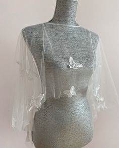 a mannequin wearing a veil with butterflies on it