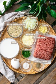 the ingredients to make this meatloaf are laid out on a wooden platter