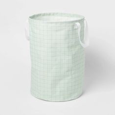 a green and white basket with handles on the side, sitting in front of a white background