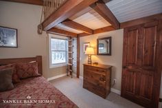 a bedroom with a bed, dresser and window