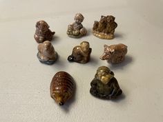 small figurines of animals and seashells on a white counter top,