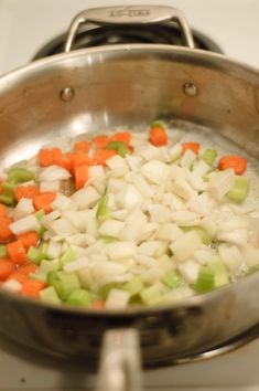 onions, carrots and celery are being cooked in a pan on the stove