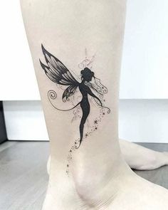 a woman's foot with a small fairy tattoo on the side of her leg