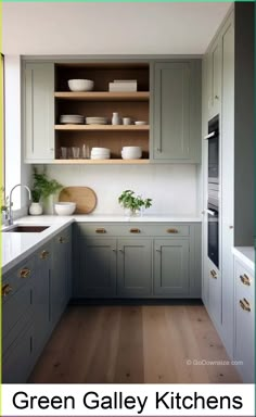 green galley kitchen cabinets with white counter tops and wood flooring in an open space