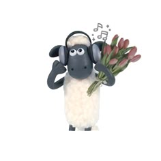 a black and white sheep with headphones on it's ears is standing in front of a white background