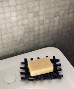 a soap bar sitting on top of a white sink