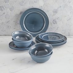 a set of blue dinnerware on a marble countertop