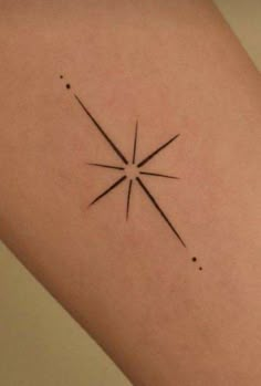 a small star tattoo on the arm