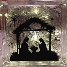 a glass nativity scene with the birth of jesus