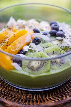 a bowl filled with fruit and nuts on top of a table