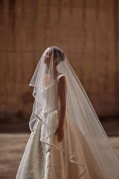 a woman in a wedding dress and veil