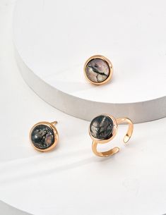 This delicate ring features stunning aquatic agate gemstones. The setting is meticulously crafted and the intricate details enhance the natural beauty of the stone, allowing its delicate hues to sparkle in the light. The adjustable strap ensures a comfortable fit, making it a versatile and elegant addition to any jewelry collection. Metal: 18K Recycled Gold Plated Vermeil on Recycled Sterling Silver,Recycled Sterling Silver Gemstone: Grass Onyx 10mm Open Ring Sizes: US 8 (Adjustable) Agate Jewelry With Natural Stones In Open Ring Shape, Elegant Jewelry With Natural Stones In Open Ring Shape, Elegant Adjustable Crystal Ring With Natural Stones, Elegant Open Ring With Natural Stones Jewelry, Elegant Open Ring With Natural Stones, Elegant Agate Rings With Natural Stones, Elegant Agate Ring With Natural Stones, Elegant Adjustable Agate Rings, Water Grass