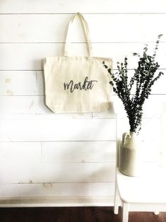 "The MARKET Oversized canvas tote bag is perfect for a trip to the farmer's market, or any Autumn outing or adventure! Shown with gray text, other colors are available... check out the variations! This bag is made from 100% thick, sturdy canvas. AVAILABLE IN TWO SIZES * Large - 19.5\" x 13\" with a 4\" gusset *Jumbo - 23\" x 13\" with a 6\" gusset (Pictured is Large) These bags are hand painted using non-toxic fabric paint. The technique used creates an attractive distressed appearance to the te Eco-friendly Natural Canvas Bag For Market, Organic Cotton Bags For Summer, Summer Organic Cotton Bags, Natural Cotton Market Bag, Eco-friendly Canvas Grocery Bag, White Eco-friendly Canvas Bag For Grocery Shopping, Eco-friendly White Canvas Grocery Bag, Eco-friendly Bags For Spring Market, Natural Cotton Grocery Bag