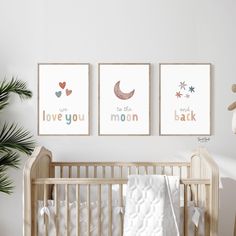 a baby's room with three posters on the wall and a crib next to it