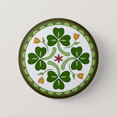 a green and white plate with four leaf clovers