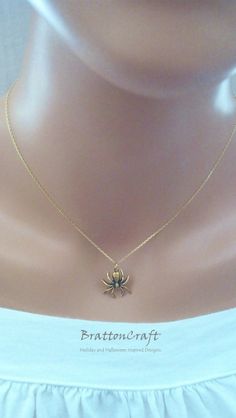 I love this Gold Spider Necklace! The charm is made of pewter, has an antique gold finish and is made in the USA. The spider is 5/8 inches long and 5/8 inches wide. The 16 inch Vermeil (gold plated sterling silver) Forzentina link chain shown is 1.1mm thick. The chain is a cable style chain with a diamond cut, finished with a spring ring clasp and made in Italy. An 18 inch chain is available in the same style along with a 20 inch box style chain. Make your selection at check out. This beautifull Collectible Gold Jewelry For Halloween, Vintage Gold Jewelry For Halloween, Gothic Gold Jewelry For Halloween, Gothic Gold Necklace For Gift, Gold Gothic Necklace For Gift, Gold Metal Necklace For Halloween, Nickel-free Gold Necklace For Halloween, Gold Spider Necklace, Spider Inspired Jewellery