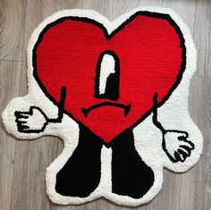 a red heart with black and white patches on it's face is sitting on the ground