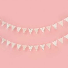 two white bunting flags on a pink background