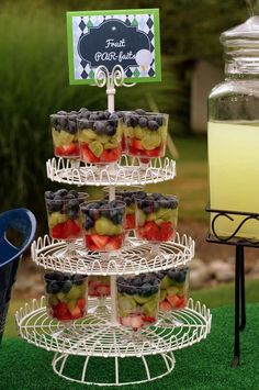 an image of a birthday party with fruit and drinks on the table in front of it