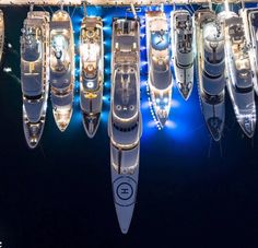 a group of boats floating in the water at night