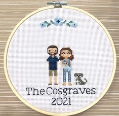 a cross stitched picture of two people holding each other with the words, the cosgraves 2011