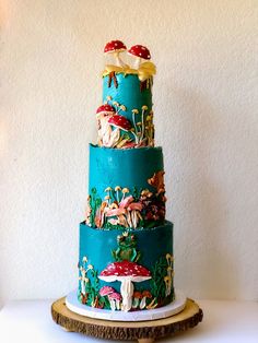 a three tiered cake with mushrooms on it