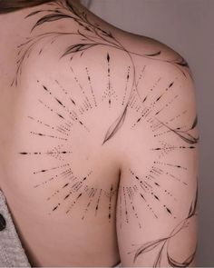 the back of a woman's shoulder with arrows drawn on it and black ink