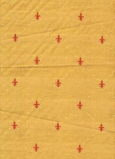 an old yellow cloth with red fleur de lis on the front and back