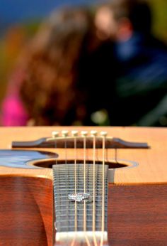 an acoustic guitar is sitting on the table