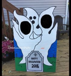 a cardboard halloween ghost with two holes in it's mouth and the words happy halloween 2016