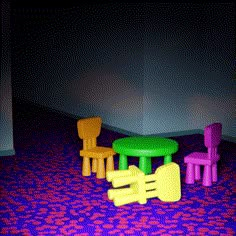 three children's plastic chairs and table in an empty room with purple flooring