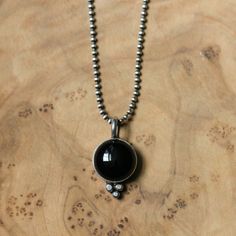 Who isn't always looking for that cross-over black necklace? Here is this gorgeous Black Onyx Pendant featuring a 12mm black agate cabochon enhanced by our traditional and delicate "Sweetheart" setting with Sterling Silver ball accents. Boho, Timeless and pretty. This Black Agate Pendant will be worn day in and day out - perfect for dressy or casual. So fun and easy to wear -- bail designed to slip on or off most chains. Necklace sold with or without 1.5 mm sterling silver beaded chain -- you ch Red Garnet Jewelry, Ocean Jasper Necklace, Sea Necklace, Black Onyx Pendant, Onyx Pendant, Black Onyx Necklace, Mabe Pearl, Agate Cabochon, Jasper Necklace