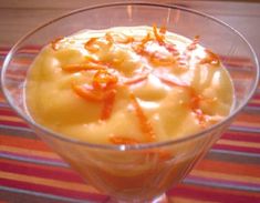 an orange dessert in a glass bowl on a table