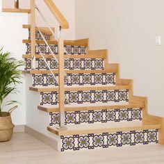 the stairs are decorated with blue and white tile designs, along with a potted plant