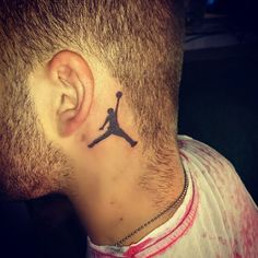 a man with a tattoo on his neck has a basketball hoop behind his ear and is looking to the side