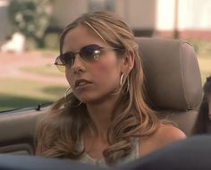 a woman sitting in the back seat of a car