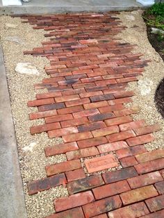 a red brick walkway in front of a house