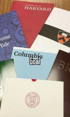 there are many different colored books on the table with words that read columbia goal and harvard