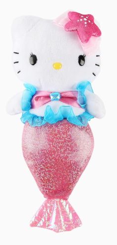 a hello kitty stuffed animal on top of a pink mermaid tail