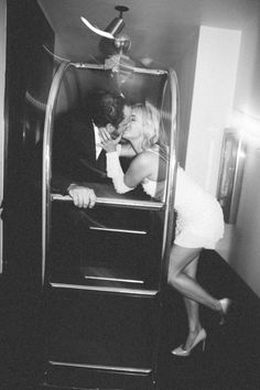 a man and woman kissing in an elevator