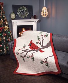 a living room with a couch, fireplace and christmas tree