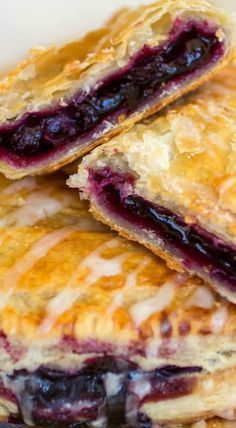 three blueberry pastries stacked on top of each other