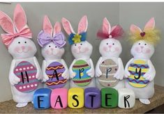 easter bunnies are lined up on a table with the word happy written in large letters